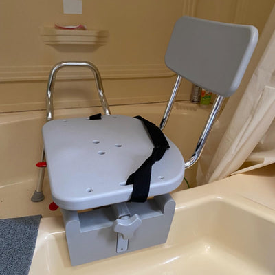 Customer photo of tub-mount shower transfer bench securely installed in bathtub with seatbelt, featuring a positive review highlighting stability and space-saving design