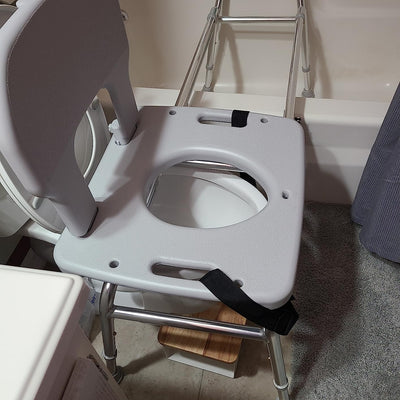 Customer review photo of a lightweight toilet-to-tub transfer bench set up in a small bathroom, praised for easy installation and smooth sliding function