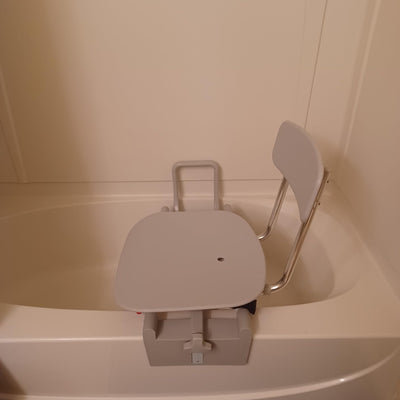 Customer review photo showing sturdy tub-mount shower chair with large seat used for an adult child with a disability