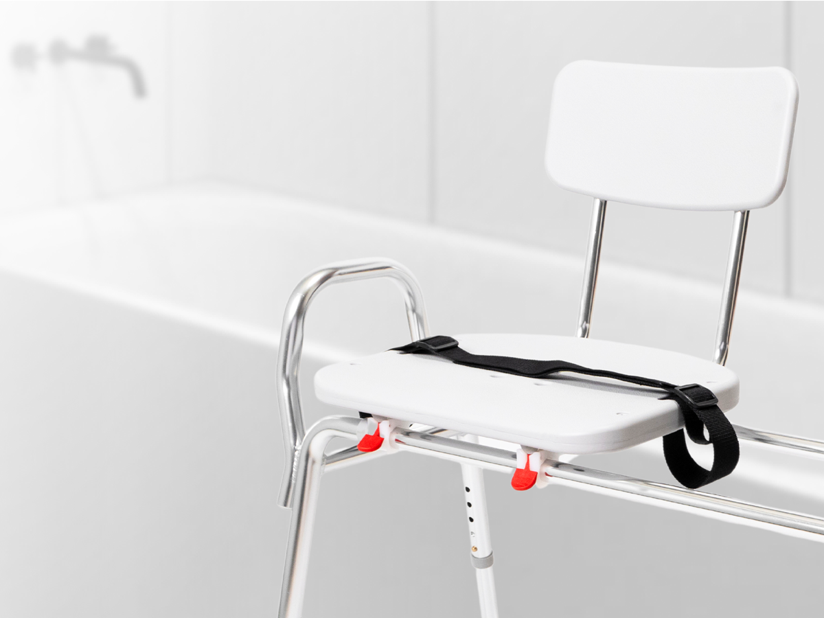Sliding transfer bench with safety belt for secure movement in and out of the bathtub