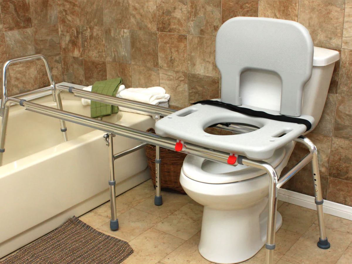 Toilet-to-tub sliding transfer bench for safe bathroom transfers in limited spaces